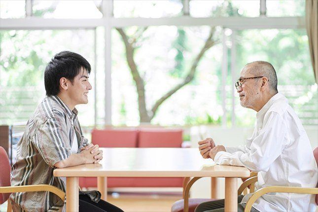 親子がテーブルで向かい合って話す場面